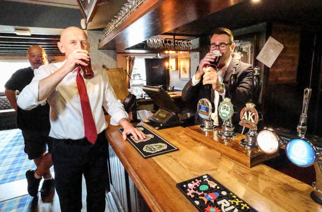 Andy Burnham visit to Harlow 23 07 2026 Britain s Prime Minister Andy Burnham speaks with locals during a visit to the Hare Inn in Harlow, east of London with the Chancellor John Healy. The UK government Thursday announced a tax cut for struggling pubs, clubs and live music venues as new Prime Minister Andy Burnham aims to ease the cost of living crisis.  Copyright: xRichardxPohlex NINTCHDBPICT001097076687