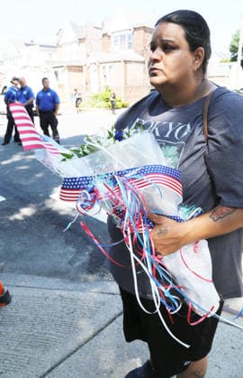 July 23, 2026, Ozone Park, New York, USA: A Queens area resident brings flowers during the memorial service for Sgt. Angel S. Rampersad. Residents in Ozone Park joined family members Thursday morning to remember Sgt. Angel Rampersad, one of four American soldiers killed in the war with Iran. Rampersad a 28-year-old soldier from Ozone Park, Queens, was killed in action during an Iranian ballistic missile and drone strike at a U.S. base in Jordan on July 17, 2026. She was among the U.S. service members to lose their lives in the escalating war. Rampersad was assigned to the 1st Battalion, 57th Air Defense Artillery Regiment. Originally from Trinidad, she attended CUNY s John Jay College of Criminal Justice before enlisting in the Army in Marc  - ZUMAb290 20260723_new_b290_222 Copyright: xDavexBurnsx