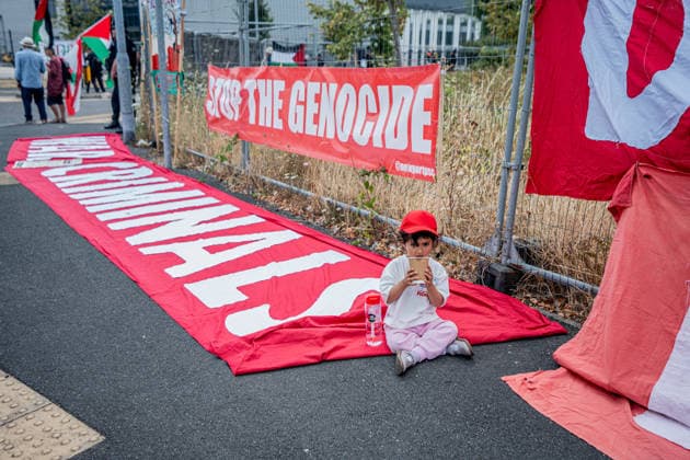 Elbit Systems Filton Bristol Pro-Palestine Protest - 23 Jul 2026 A young child sits alongside a large banner accusing Israel of being war criminals and causing a genocide in Gaza during the rally. Pro-Palestinian protestors gathered outside Elbit Systems factory in Filton, Bristol to accuse the arms company of supplying Israel with weaponry and drones for its war in Gaza. Bristol United Kingdom Copyright: xLabxMox xSOPAxImagesx LabMO_Elbit_Systems_Filton_Protest_Sopa_5.jpeg