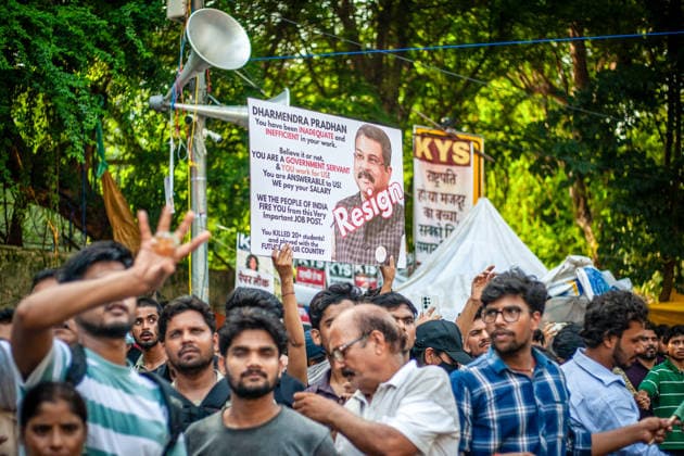New Delhi Exam Leak Protest A placard demanding the resignation of Union Education Minister Dharmendra Pradhan is raised above demonstrators at Jantar Mantar in New Delhi, India, on July 23, 2026. The Cockroach Janta Party (CJP) organized the youth protest over national examination paper leaks, including NEET and CBSE examinations, and called for the resignation of Union Education Minister Dharmendra Pradhan. New Delhi Delhi India Copyright: xYousufxSarfarazx