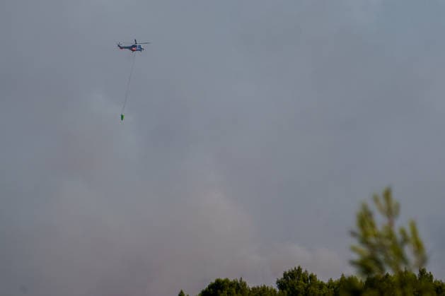 Wildfire reignites with strong Mistral wind in France. France - Cotignac, 23.07.2026 A Helicopter in the clouds of smoke as a wildfire spreads again near Cotignac in the Var department, southeastern France on Thursday. Strong Mistral winds fueled renewed fire activity, prompting a large firefighting operation. Departement Var