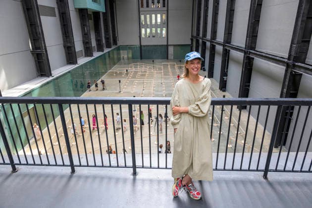 July 24, 2026, London, London, UK: Artist Lina LapelytÄ poses with her created maze-like installation, transforming the Turbine Hall into a collaborative stage. Audiences are invited to co-create in a piece of mass choreography, moving through a grid of wooden barriers. You are also free to quietly watch the performance unfold, from the Turbine Hall bridge. London, UK. London UK  - ZUMAl94_ 20260724_zaf_l94_002 Copyright: xRayxTangx