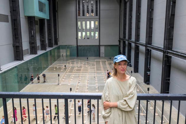 July 24, 2026, London, London, UK: Artist Lina LapelytÄ poses with her created maze-like installation, transforming the Turbine Hall into a collaborative stage. Audiences are invited to co-create in a piece of mass choreography, moving through a grid of wooden barriers. You are also free to quietly watch the performance unfold, from the Turbine Hall bridge. London, UK. London UK  - ZUMAl94_ 20260724_zaf_l94_003 Copyright: xRayxTangx