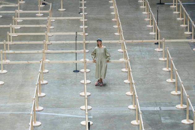 July 24, 2026, London, London, UK: Artist Lina LapelytÄ poses with her created maze-like installation, transforming the Turbine Hall into a collaborative stage. Audiences are invited to co-create in a piece of mass choreography, moving through a grid of wooden barriers. You are also free to quietly watch the performance unfold, from the Turbine Hall bridge. London, UK. London UK  - ZUMAl94_ 20260724_zaf_l94_008 Copyright: xRayxTangx
