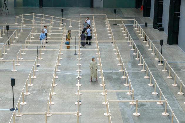 July 24, 2026, London, London, UK: Artist Lina LapelytÄ poses with her created maze-like installation, transforming the Turbine Hall into a collaborative stage. Audiences are invited to co-create in a piece of mass choreography, moving through a grid of wooden barriers. You are also free to quietly watch the performance unfold, from the Turbine Hall bridge. London, UK. London UK  - ZUMAl94_ 20260724_zaf_l94_009 Copyright: xRayxTangx