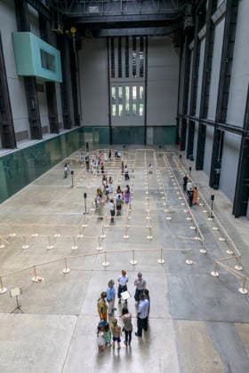 July 24, 2026, London, London, UK: Visitors interact with artist Lina LapelytÄ Ã¢â‚¬â ¢created maze-like installation, transforming the Turbine Hall into a collaborative stage. Audiences are invited to co-create in a piece of mass choreography, moving through a grid of wooden barriers. You are also free to quietly watch the performance unfold, from the Turbine Hall bridge. London, UK. London UK  - ZUMAl94_ 20260724_zaf_l94_010 Copyright: xRayxTangx