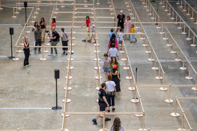 July 24, 2026, London, London, UK: Visitors interact with artist Lina LapelytÄ Ã¢â‚¬â ¢created maze-like installation, transforming the Turbine Hall into a collaborative stage. Audiences are invited to co-create in a piece of mass choreography, moving through a grid of wooden barriers. You are also free to quietly watch the performance unfold, from the Turbine Hall bridge. London, UK. London UK  - ZUMAl94_ 20260724_zaf_l94_013 Copyright: xRayxTangx