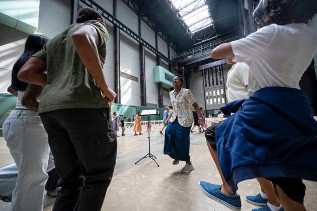 July 24, 2026, London, London, UK: LONDON, UK. Visitors receiving instructions. Preview of UNIQLO Tate Play Lina Lapelyte, Serendipity Island in the Turbine Hall at Tate Modern. Lithuanian born artist Lina Lapelyte (pictured) has created a maze of barriers and encourages visitors to move through, using simple actions such as stomping, jumping and singing, in time with an accompanying soundscape to create a piece of collective choreography. The work is in place 25 July to 31 August 2026. London UK  - ZUMAl94_ 20260724_zaf_l94_032 Copyright: xStephenxChungx