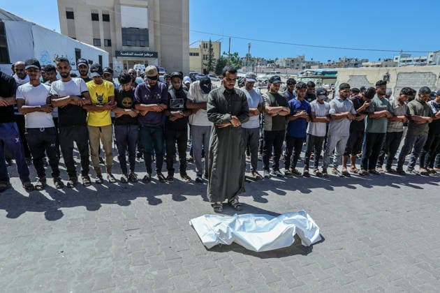 The Israeli army continues its attacks on the Gaza Strip despite the ceasefire DEIR AL BALAH, GAZA, PALESTINE - JULY 24: Citizens and relatives of the Palestinians, who died as a result of the Israeli forces violated the ceasefire and opened fire on the Al-Mawasi area, where Palestinian tents are located, in the city of Khan Yunis, perform the funeral prayer after bodies were taken from the al-Aqsa Martyrs Hospital in Deir al-Balah, Gaza, Palestine on July 24, 2026. Abed Rahim Khatib Anadolu Deir al-Balah Gaza. Editorial use only. Please get in touch for any other usage.  Copyright: x2026xAnadoluxAbedxRahimxKhatibx