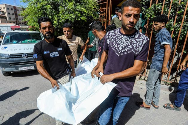 The Israeli army continues its attacks on the Gaza Strip despite the ceasefire DEIR AL BALAH, GAZA, PALESTINE - JULY 24: Citizens and relatives of the Palestinians, who died as a result of the Israeli forces violated the ceasefire and opened fire on the Al-Mawasi area, where Palestinian tents are located, in the city of Khan Yunis, carry the dead bodies for burial at the al-Aqsa Martyrs Hospital in Deir al-Balah, Gaza, Palestine on July 24, 2026. Abed Rahim Khatib Anadolu Deir al-Balah Gaza. Editorial use only. Please get in touch for any other usage.  Copyright: x2026xAnadoluxAbedxRahimxKhatibx