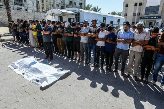 The Israeli army continues its attacks on the Gaza Strip despite the ceasefire DEIR AL BALAH, GAZA, PALESTINE - JULY 24: Citizens and relatives of the Palestinians, who died as a result of the Israeli forces violated the ceasefire and opened fire on the Al-Mawasi area, where Palestinian tents are located, in the city of Khan Yunis, perform the funeral prayer after bodies were taken from the al-Aqsa Martyrs Hospital in Deir al-Balah, Gaza, Palestine on July 24, 2026. Abed Rahim Khatib Anadolu Deir al-Balah Gaza. Editorial use only. Please get in touch for any other usage.  Copyright: x2026xAnadoluxAbedxRahimxKhatibx