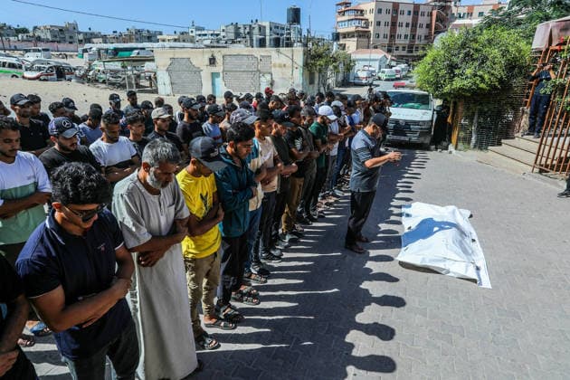 The Israeli army continues its attacks on the Gaza Strip despite the ceasefire DEIR AL BALAH, GAZA, PALESTINE - JULY 24: Citizens and relatives of the Palestinians, who died as a result of the Israeli forces violated the ceasefire and opened fire on the Al-Mawasi area, where Palestinian tents are located, in the city of Khan Yunis, perform the funeral prayer after bodies were taken from the al-Aqsa Martyrs Hospital in Deir al-Balah, Gaza, Palestine on July 24, 2026. Abed Rahim Khatib Anadolu Deir al-Balah Gaza. Editorial use only. Please get in touch for any other usage.  Copyright: x2026xAnadoluxAbedxRahimxKhatibx