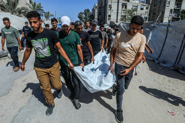 The Israeli army continues its attacks on the Gaza Strip despite the ceasefire DEIR AL BALAH, GAZA, PALESTINE - JULY 24: Citizens and relatives of the Palestinians, who died as a result of the Israeli forces violated the ceasefire and opened fire on the Al-Mawasi area, where Palestinian tents are located, in the city of Khan Yunis, carry the dead bodies for burial at the al-Aqsa Martyrs Hospital in Deir al-Balah, Gaza, Palestine on July 24, 2026. Abed Rahim Khatib Anadolu Deir al-Balah Gaza. Editorial use only. Please get in touch for any other usage.  Copyright: x2026xAnadoluxAbedxRahimxKhatibx
