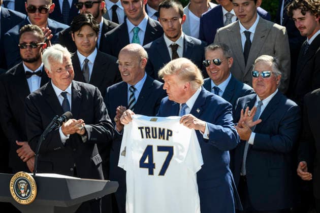 July 24, 2026, Washington, Dc, United States: U.S. President Donald Trump, holds up a team jersey during a celebration of their 2025 MLB World Series championship, at the Rose Garden of the White House, July 23, 2026, in Washington, D.C. Washington United States - ZUMAp138 20260724_zaa_p138_059 Copyright: xMollyxRiley WhitexHousex