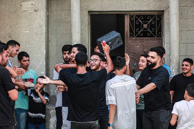 Gaza Families Celebrate Tawjihi Success Palestinian men and boys gather during celebrations of the Tawjihi results in Gaza City, northern Gaza Strip, on July 23, 2026. Families in displacement camps and neighborhoods across northern Gaza City held modest celebrations for students who passed the Tawjihi examinations amid war, blockade and severe humanitarian conditions. Gaza Gaza Strip Palestinian Territories Copyright: xFaizxQreqax