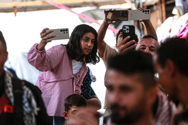Gaza Families Celebrate Tawjihi Success A Palestinian girl records the gathering on a mobile phone as others hold up their phones during celebrations of the Tawjihi results in Gaza City, northern Gaza Strip, on July 23, 2026. Families in displacement camps and neighborhoods across northern Gaza City held modest celebrations for students who passed the Tawjihi examinations amid war, blockade and severe humanitarian conditions. Gaza Gaza Strip Palestinian Territories Copyright: xFaizxQreqax