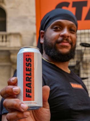 July 24, 2026, New York, New York, USA: Giving out Fearless Girl water at the Fearless Girl Block Party outside the NYSE. The Ten Year anniversary of the.girl empowering sculpture by Kristen Visbal was celebrated with music, free giveaways, and.live vendors. The event pays homage to the millions who line up to be photographed with her..State Street an exchange traded fund commissioned the art work in 2017 which originally stood opposite the .Wall Street Charging Bull but was moved to opposite the Stock Excahnge encouraging girls theu can do anything. New York USA - ZUMAh156 20260724_znp_h156_001 Copyright: xMiloxHessx