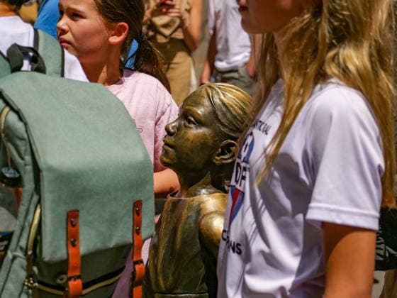July 24, 2026, New York, New York, USA: The Statue surrounded by girls posing at Fearless Girl Block Party outside the NYSE. The Ten Year anniversary of the.girl empowering sculpture by Kristen Visbal was celebrated with music, free giveaways, and.live vendors. The event pays homage to the millions who line up to be photographed with her..State Street an exchange traded fund commissioned the art work in 2017 which originally stood opposite the .Wall Street Charging Bull but was moved to opposite the Stock Excahnge encouraging girls theu can do anything. New York USA  - ZUMAh156 20260724_znp_h156_005 Copyright: xMiloxHessx