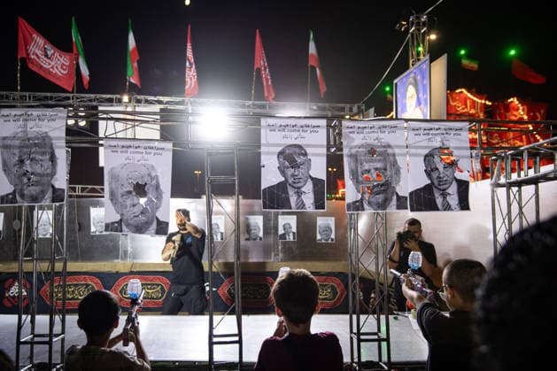 Demonstrators shoot at photos of US President Donald Trump and Israeli Prime Minister Benjamin Netanyahu with pellet guns during a pro‘government protest in Tehran, Iran on Friday, July 24, 2026. U.S. and Iran traded attacks for the 13th night in a row with few signs of either side returning to negociations.  IRN2026072414 BehnamxTofighi