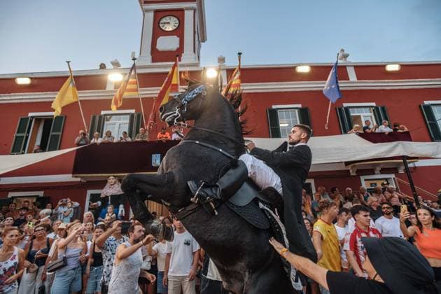July 24, 2026, Es Castell, Menorca Balearic Islands, Spain: A caixer, or horse rider, rears his horse amid a cheering crowd during the traditional Jaleo at the Sant MartoÂ­ Festival in Es Castell. Es Castell Spain  - ZUMAo105 20260724_fap_o105_012 Copyright: xMatthiasxOesterlex