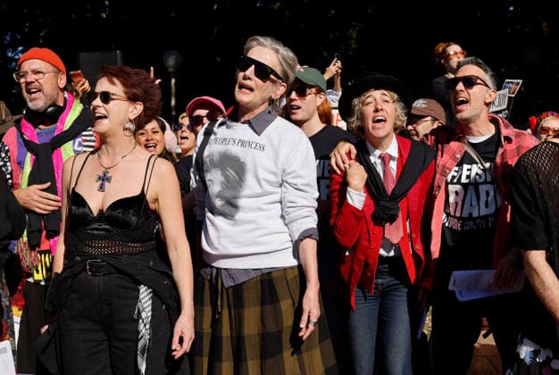 SING-IN PROTEST, People sing and dance during a Sing-In™ protest in solidarity with Divine Playhouse at Hyde Park in Sydney, Saturday, July 25, 2026. The Trans Theatre Group was evicted from its rental property in Kent Street after its landlord Revelop terminated the venue s lease claiming offensive trade - a legal term deriving from an 1842 NSW law implemented to regulate foul smells and industrial waste - and never once in 184 years has a court been asked to consider if it extends to moral offensiveness. ( NO ARCHIVING SYDNEY NEW SOUTH WALES AUSTRALIA  Copyright: xJESSICAxHROMASx 20260725148588934860