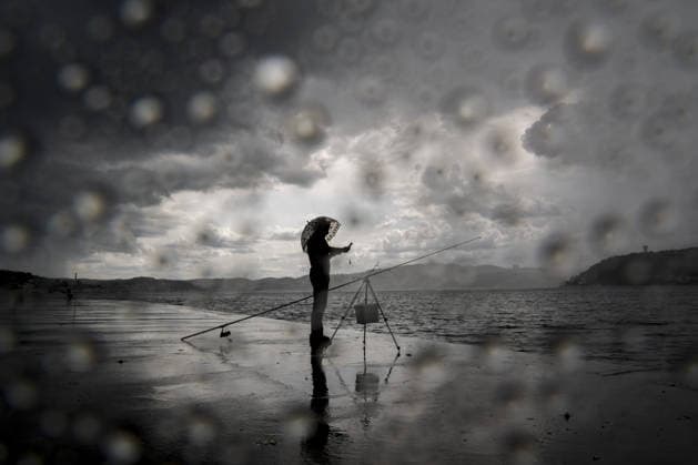Heavy summer rainfall affects parts of Istanbul ISTANBUL, TURKIYE – JULY 25: A fisherman stands under an umbrella along the Bosphorus waterfront during rainfall in Istanbul, Turkiye, on July 25, 2026. Dark clouds gathered over parts of the city as periods of summer rain passed through. Arife Karakum Anadolu Istanbul Turkey. Editorial use only. Please get in touch for any other usage.  Copyright: x2026xAnadoluxArifexKarakumx