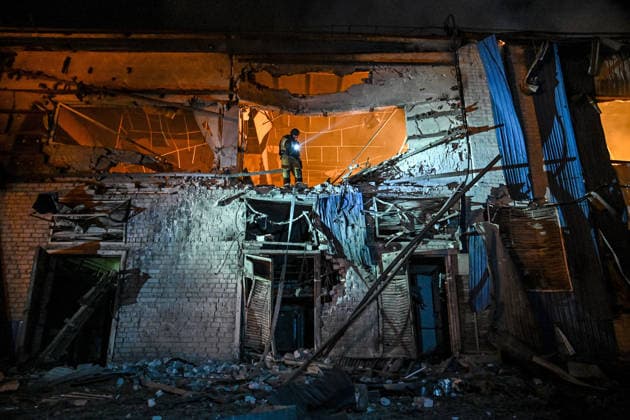 A rescuer extinguishes a fire at a shopping complex caused by a Russian attack in Zaporizhzhia, Ukraine, July 25, 2026. In the early hours of Saturday, July 25, Russian troops struck the southeastern Ukrainian city with drones, igniting a fire that spread through shops and trading pavilions over an area of about 900 square metres. A 63-year-old man was injured in the drone strike. (Photo by Dmytro Smolienko Ukrinform) Russian army attacks Zaporizhzhia with drones  Copyright: xDmytroxSmolienkox