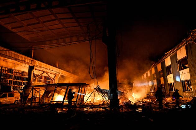 A rescuer extinguishes a fire at a shopping complex caused by a Russian attack in Zaporizhzhia, Ukraine, July 25, 2026. In the early hours of Saturday, July 25, Russian troops struck the southeastern Ukrainian city with drones, igniting a fire that spread through shops and trading pavilions over an area of about 900 square metres. A 63-year-old man was injured in the drone strike. (Photo by Dmytro Smolienko Ukrinform) Russian army attacks Zaporizhzhia with drones  Copyright: xDmytroxSmolienkox