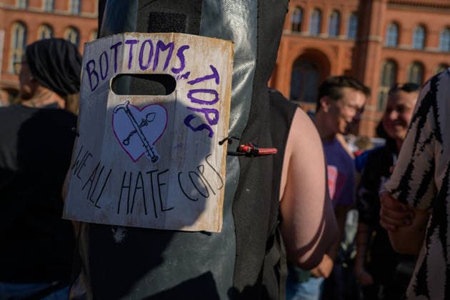 July 24, 2026, Berlin, Berlin, Germany: A person mounts a placard against police on their backpack at Dyke* March 2026, on July 24 2026, in Berlin, Germany. Thousands of demonstrators marched in the streets of Berlin s City Center and Kreuzberg districts for the annual Dyke* March just a day before the annual CSD parade and Internationalist Queer Pride Berlin Germany  - ZUMAk201 20260724_zip_k201_002 Copyright: xNikosxKanistrasx