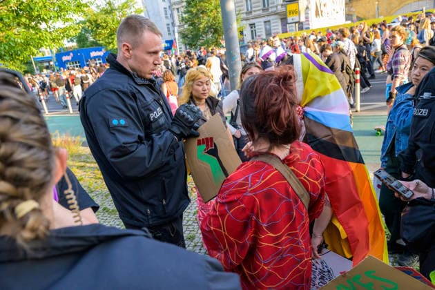 July 24, 2026, Berlin, Berlin, Germany: A police officer arrest one of the demonstrators because they hold a placard of a fist painted in the Palestine s flag colors at Dyke* March 2026, on July 24 2026, in Berlin, Germany. Thousands of demonstrators marched in the streets of Berlin s City Center and Kreuzberg districts for the annual Dyke* March just a day before the annual CSD parade and Internationalist Queer Pride Berlin Germany  - ZUMAk201 20260724_zip_k201_011 Copyright: xNikosxKanistrasx
