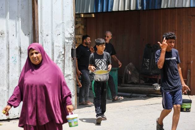 July 26, 2026, Al-Nuseirat Camp, Palestine, State of: AL-NUSEIRAT CAMP, GAZA STRIP Ã¢â‚¬ JULY 25, 2026: A charity kitchen in al-Nuseirat continues to distribute hot meals to displaced Palestinians, amid a severe hunger crisis driven by ongoing restrictions on humanitarian aid entry and a sharp decline in international funding for charity kitchens. Thousands of displaced familiesoÅ’ including children, women, and the elderlyoÅ’ rely on these kitchens as their near-sole source of daily meals, as UN agencies warn of worsening famine conditions across the Strip. Al-Nuseirat Camp Palestine, State of - ZUMAq101 20260726_zna_q101_002 Copyright: xRamzixAbuxAmerx