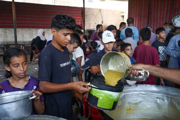 July 25, 2026, Al-Nuseirat Camp, Palestine, State of: AL-NUSEIRAT CAMP, GAZA STRIP Ã¢â‚¬ JULY 25, 2026: A charity kitchen in al-Nuseirat continues to distribute hot meals to displaced Palestinians, amid a severe hunger crisis driven by ongoing restrictions on humanitarian aid entry and a sharp decline in international funding for charity kitchens. Thousands of displaced familiesoÅ’ including children, women, and the elderlyoÅ’ rely on these kitchens as their near-sole source of daily meals, as UN agencies warn of worsening famine conditions across the Strip. Al-Nuseirat Camp Palestine, State of - ZUMAq101 20260725_zna_q101_005 Copyright: xRamzixAbuxAmerx