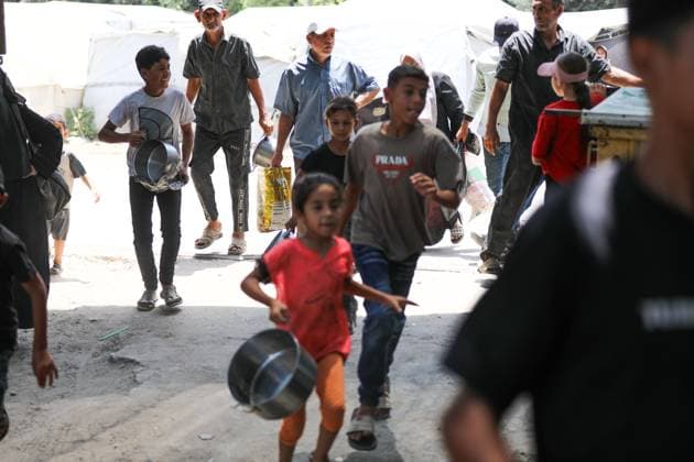 July 26, 2026, Al-Nuseirat Camp, Palestine, State of: AL-NUSEIRAT CAMP, GAZA STRIP Ã¢â‚¬ JULY 25, 2026: A charity kitchen in al-Nuseirat continues to distribute hot meals to displaced Palestinians, amid a severe hunger crisis driven by ongoing restrictions on humanitarian aid entry and a sharp decline in international funding for charity kitchens. Thousands of displaced familiesoÅ’ including children, women, and the elderlyoÅ’ rely on these kitchens as their near-sole source of daily meals, as UN agencies warn of worsening famine conditions across the Strip. Al-Nuseirat Camp Palestine, State of - ZUMAq101 20260726_zna_q101_008 Copyright: xRamzixAbuxAmerx