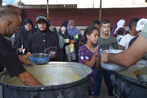 July 25, 2026, Al-Nuseirat Camp, Palestine, State of: AL-NUSEIRAT CAMP, GAZA STRIP Ã¢â‚¬ JULY 25, 2026: A charity kitchen in al-Nuseirat continues to distribute hot meals to displaced Palestinians, amid a severe hunger crisis driven by ongoing restrictions on humanitarian aid entry and a sharp decline in international funding for charity kitchens. Thousands of displaced familiesoÅ’ including children, women, and the elderlyoÅ’ rely on these kitchens as their near-sole source of daily meals, as UN agencies warn of worsening famine conditions across the Strip. Al-Nuseirat Camp Palestine, State of - ZUMAq101 20260725_zna_q101_009 Copyright: xRamzixAbuxAmerx