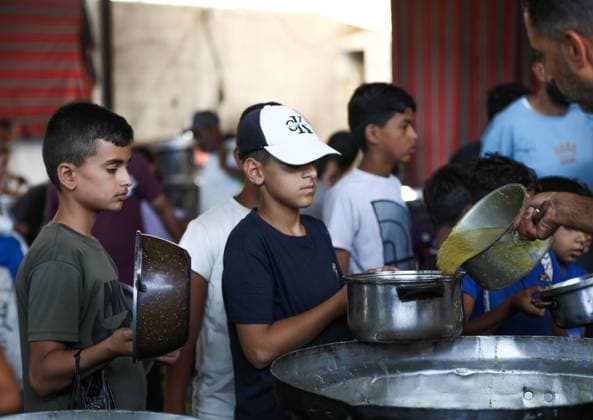 July 26, 2026, Al-Nuseirat Camp, Palestine, State of: AL-NUSEIRAT CAMP, GAZA STRIP Ã¢â‚¬ JULY 25, 2026: A charity kitchen in al-Nuseirat continues to distribute hot meals to displaced Palestinians, amid a severe hunger crisis driven by ongoing restrictions on humanitarian aid entry and a sharp decline in international funding for charity kitchens. Thousands of displaced familiesoÅ’ including children, women, and the elderlyoÅ’ rely on these kitchens as their near-sole source of daily meals, as UN agencies warn of worsening famine conditions across the Strip. Al-Nuseirat Camp Palestine, State of - ZUMAq101 20260726_zna_q101_005 Copyright: xRamzixAbuxAmerx