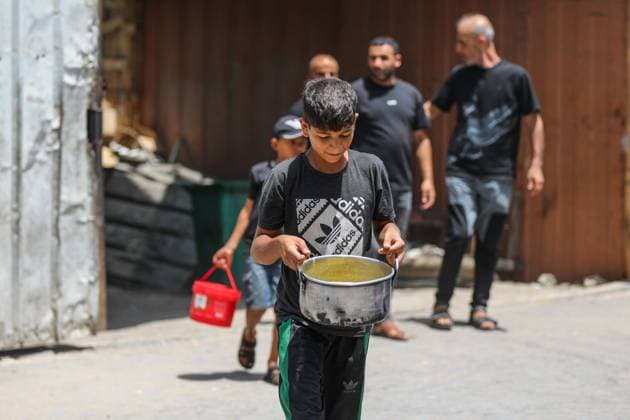 July 26, 2026, Al-Nuseirat Camp, Palestine, State of: AL-NUSEIRAT CAMP, GAZA STRIP Ã¢â‚¬ JULY 25, 2026: A charity kitchen in al-Nuseirat continues to distribute hot meals to displaced Palestinians, amid a severe hunger crisis driven by ongoing restrictions on humanitarian aid entry and a sharp decline in international funding for charity kitchens. Thousands of displaced familiesoÅ’ including children, women, and the elderlyoÅ’ rely on these kitchens as their near-sole source of daily meals, as UN agencies warn of worsening famine conditions across the Strip. Al-Nuseirat Camp Palestine, State of - ZUMAq101 20260726_zna_q101_013 Copyright: xRamzixAbuxAmerx