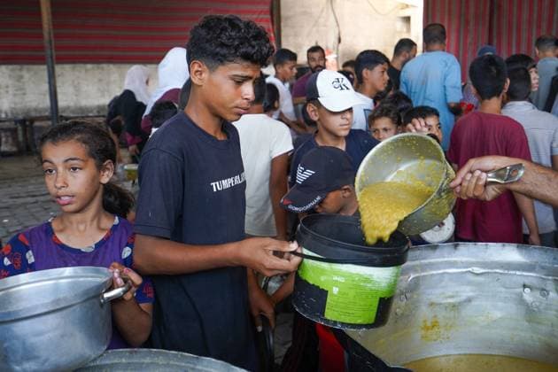 July 25, 2026, Al-Nuseirat Camp, Palestine, State of: AL-NUSEIRAT CAMP, GAZA STRIP Ã¢â‚¬ JULY 25, 2026: A charity kitchen in al-Nuseirat continues to distribute hot meals to displaced Palestinians, amid a severe hunger crisis driven by ongoing restrictions on humanitarian aid entry and a sharp decline in international funding for charity kitchens. Thousands of displaced familiesoÅ’ including children, women, and the elderlyoÅ’ rely on these kitchens as their near-sole source of daily meals, as UN agencies warn of worsening famine conditions across the Strip. Al-Nuseirat Camp Palestine, State of - ZUMAq101 20260725_zna_q101_013 Copyright: xRamzixAbuxAmerx