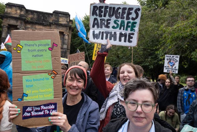 July 25, 2026, Glasgow, Scotland, UK: Pro-immigration protesters aligned with Stand Up To Racism Scotland and other allied organisations hold placards and banners during a demonstration in Glasgow. The protest took place amid heightened tensions over immigration and asylum seekers following months of unrest and protests across Scotland and was met with a counter protest held by anti-immigration supporters. Glasgow UK  - ZUMAs357 20260725_zip_s357_005 Copyright: xCameronxScottx