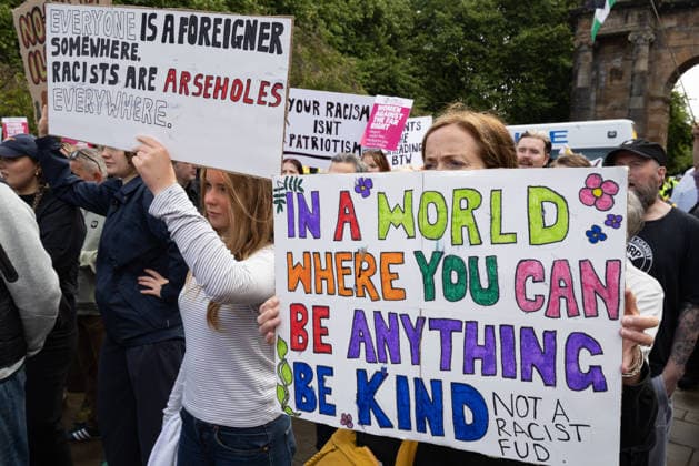 July 25, 2026, Glasgow, Scotland, UK: Pro-immigration protesters aligned with Stand Up To Racism Scotland and other allied organisations hold placards and banners during a demonstration in Glasgow. The protest took place amid heightened tensions over immigration and asylum seekers following months of unrest and protests across Scotland and was met with a counter protest held by anti-immigration supporters. Glasgow UK  - ZUMAs357 20260725_zip_s357_007 Copyright: xCameronxScottx