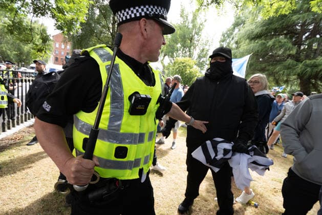 July 25, 2026, Glasgow, Scotland, UK: Police officers contain rival groups of pro- and anti-immigration protesters during a demonstration in Glasgow amid heightened tensions over immigration and asylum seekers. Protesters aligned with Unite The Clans Scotland, which describes itself as a patriotic group, were met by a counter-demonstration led by Stand Up To Racism Scotland and other allied organisations. Glasgow UK  - ZUMAs357 20260725_zip_s357_009 Copyright: xCameronxScottx