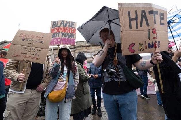 July 25, 2026, Glasgow, Scotland, UK: Pro-immigration protesters aligned with Stand Up To Racism Scotland and other allied organisations hold placards and banners during a demonstration in Glasgow. The protest took place amid heightened tensions over immigration and asylum seekers following months of unrest and protests across Scotland and was met with a counter protest held by anti-immigration supporters. Glasgow UK - ZUMAs357 20260725_zip_s357_004 Copyright: xCameronxScottx