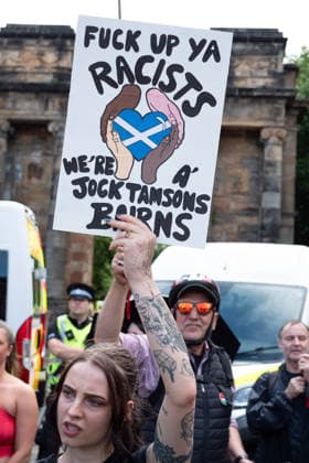 July 25, 2026, Glasgow, Scotland, UK: Pro-immigration protesters aligned with Stand Up To Racism Scotland and other allied organisations hold placards and banners during a demonstration in Glasgow. The protest took place amid heightened tensions over immigration and asylum seekers following months of unrest and protests across Scotland and was met with a counter protest held by anti-immigration supporters. Glasgow UK - ZUMAs357 20260725_zip_s357_014 Copyright: xCameronxScottx