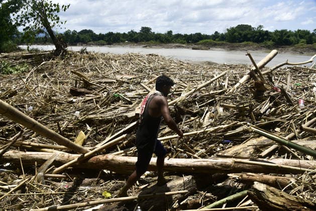 Aftermath of the flood in India s Sivasagar SIVASAGAR, INDIA - JULY 25: A flood-affected man stands amid a vast field of debris, pointing toward the destruction left behind by powerful floodwaters in Sivasagar, Assam, India on on Saturday, July 25, 2026. Hafiz Ahmed Anadolu Sivasagar India. Editorial use only. Please get in touch for any other usage.  Copyright: x2026xAnadoluxHafizxAhmedx