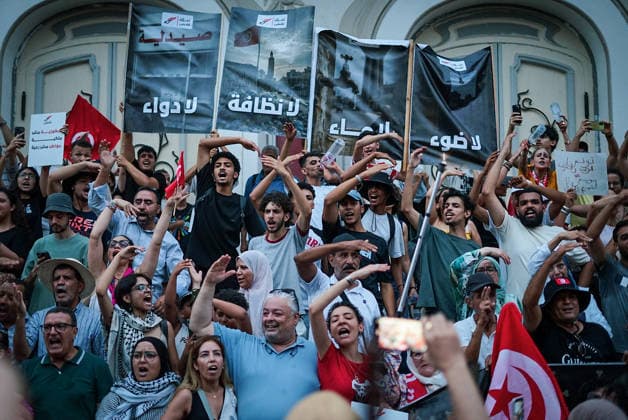 July 25, 2026, Tunis, Tunis, Tunisia, Tunisia: People hold placards and chant slogans during a protest against Tunisian President Kais Saied in downtown Tunis, Tunisia, on July 25, 2026. Demonstrators gathered on Republic Day to denounce the government s handling of prolonged power outages and recurring water cuts affecting regions across the country, while also criticizing President Saied s rule and demanding political and economic reforms. Tunis Tunisia  - ZUMAm342 20260725_zsp_m342_020 Copyright: xHasanxMradx