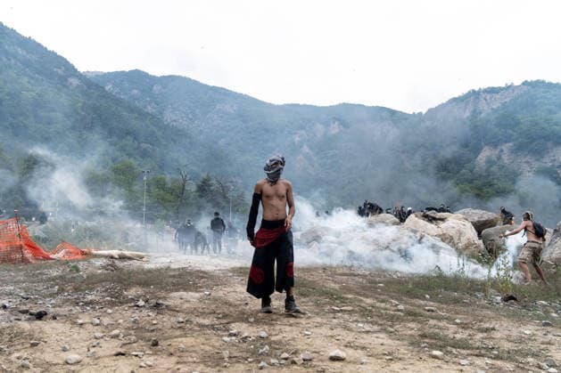 July 25, 2026, Susa, Piedmont, Italy: On July 25, 2026, thousands of people departed from AltaFelicito , a music festival in Venaus, to reach the construction sites of the TAV (High speed rail), a railway project to connect Italy and France. The demonstrators managed to enter the site and there clashed with the police, who responded with tear gas. Many of the buildings inside were put on fire, including two police vehicles. The TAV project has been highly contested during the last 30 years because of environmental damages and increasing costs. Susa Italy  - ZUMAs377 20260725_znp_s377_008 Copyright: xPietroxStariccox