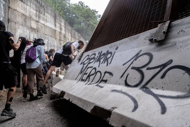 July 25, 2026, Susa, Piedmont, Italy: On July 25, 2026, thousands of people departed from AltaFelicito , a music festival in Venaus, to reach the construction sites of the TAV (High speed rail), a railway project to connect Italy and France. The demonstrators managed to enter the site and there clashed with the police, who responded with tear gas. Many of the buildings inside were put on fire, including two police vehicles. The TAV project has been highly contested during the last 30 years because of environmental damages and increasing costs. Susa Italy  - ZUMAs377 20260725_znp_s377_010 Copyright: xPietroxStariccox