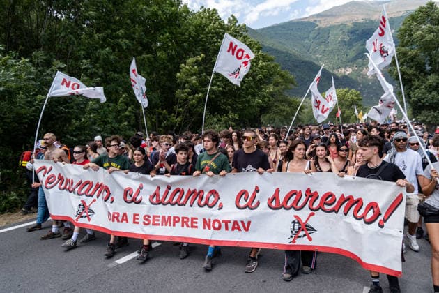 July 25, 2026, Susa, Piedmont, Italy: On July 25, 2026, thousands of people departed from AltaFelicito , a music festival in Venaus, to reach the construction sites of the TAV (High speed rail), a railway project to connect Italy and France. The demonstrators managed to enter the site and there clashed with the police, who responded with tear gas. Many of the buildings inside were put on fire, including two police vehicles. The TAV project has been highly contested during the last 30 years because of environmental damages and increasing costs. Susa Italy  - ZUMAs377 20260725_znp_s377_012 Copyright: xPietroxStariccox
