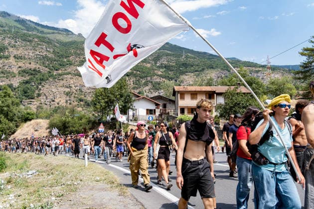 July 25, 2026, Susa, Piedmont, Italy: On July 25, 2026, thousands of people departed from AltaFelicito , a music festival in Venaus, to reach the construction sites of the TAV (High speed rail), a railway project to connect Italy and France. The demonstrators managed to enter the site and there clashed with the police, who responded with tear gas. Many of the buildings inside were put on fire, including two police vehicles. The TAV project has been highly contested during the last 30 years because of environmental damages and increasing costs. Susa Italy  - ZUMAs377 20260725_znp_s377_019 Copyright: xPietroxStariccox