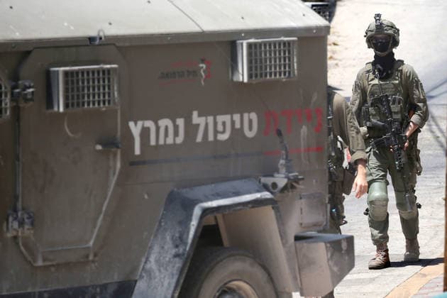 July 25, 2026, Nablus, West Bank, Palestine: Israeli soldiers take positions as they guard the military vehicles during the siege of the home of the Palestinian man who shot a settler in self-defense after a group of Jewish settlers stormed his house. This attack came in retaliation for the killing of two settlers and four Palestinians in Tell, southwest of Nablus in the West Bank. In response, settlers set fire to Palestinian cars and homes in Tell and the neighboring village of Qalqilya Sara. Meanwhile, the Israeli army announced its readiness for a military operation in the northern West Bank, which is under the control of the Palestinian Authority. Nablus Palestine - ZUMAs197 20260725_aaa_s197_227 Copyright: xNasserxishatyehx