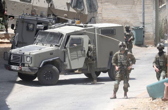 July 25, 2026, Nablus, West Bank, Palestine: Israeli soldiers take positions as they guard the military vehicles during the siege of the home of the Palestinian man who shot a settler in self-defense after a group of Jewish settlers stormed his house. This attack came in retaliation for the killing of two settlers and four Palestinians in Tell, southwest of Nablus in the West Bank. In response, settlers set fire to Palestinian cars and homes in Tell and the neighboring village of Qalqilya Sara. Meanwhile, the Israeli army announced its readiness for a military operation in the northern West Bank, which is under the control of the Palestinian Authority. Nablus Palestine - ZUMAs197 20260725_aaa_s197_246 Copyright: xNasserxishatyehx